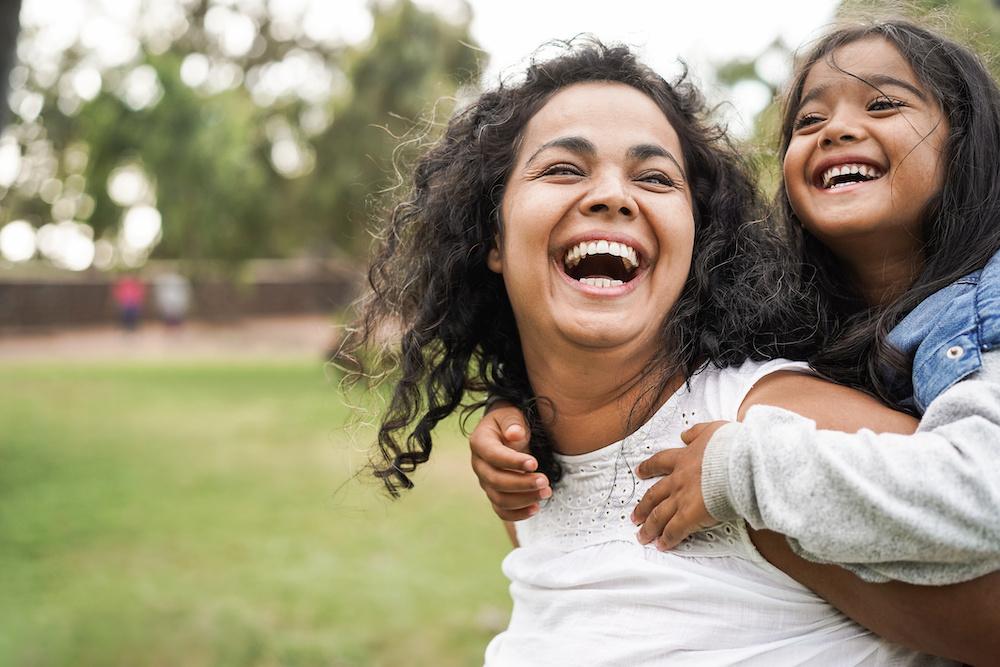 Mother and daughter smiling outside, charlotte nc