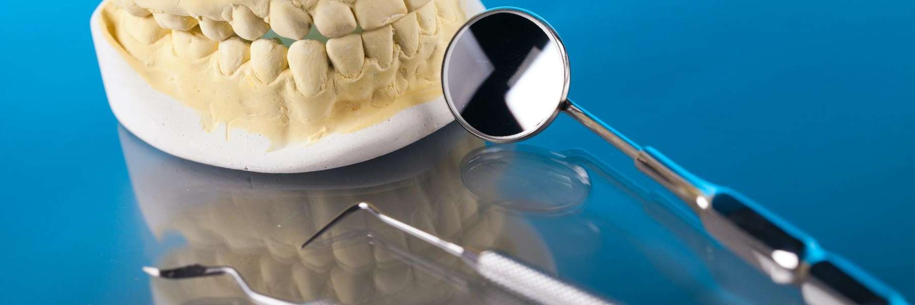Dentist tools next to a clay mold of a mouth, Charlotte NC