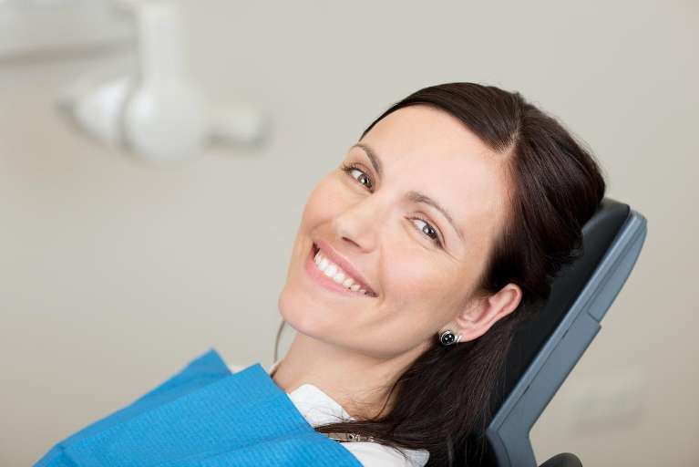 Woman smiling in dental chair, charlotte nc