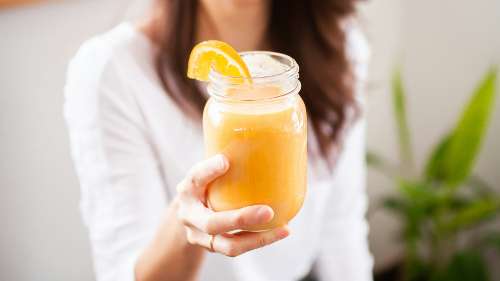 Woman holding a glass of juice, charlotte nc