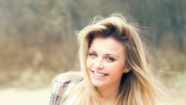 A smiling woman at the park