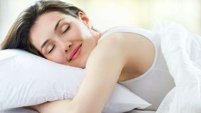 Woman lying on pillow sleeping with smile, charlotte north carolina