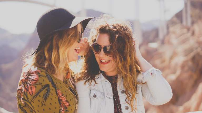 Two friends laughing outdoors