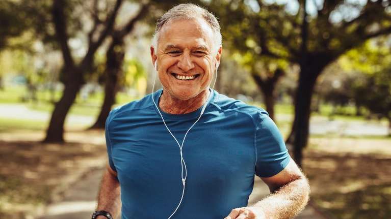 A man jogging in the park | Dental Bridges in Charlotte
