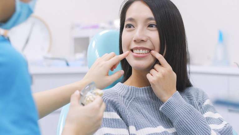 Asian woman getting her teeth checked at dentist, charlotte nc