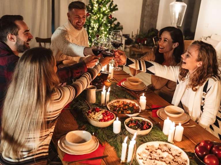 A group of friends having holiday dinner | dentist Charlotte NC