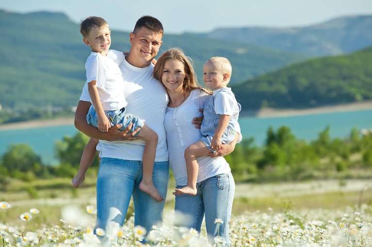Mother and father with two sons in a meadow, charlotte nc